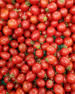 A pile of red tomatoes, unpackaged.