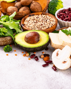 Avocado, mushrooms and assorted legumes on a table.