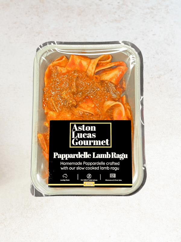 Top down product shot of a ready-made Pappardelle Lamb Ragu in a container with a black label.